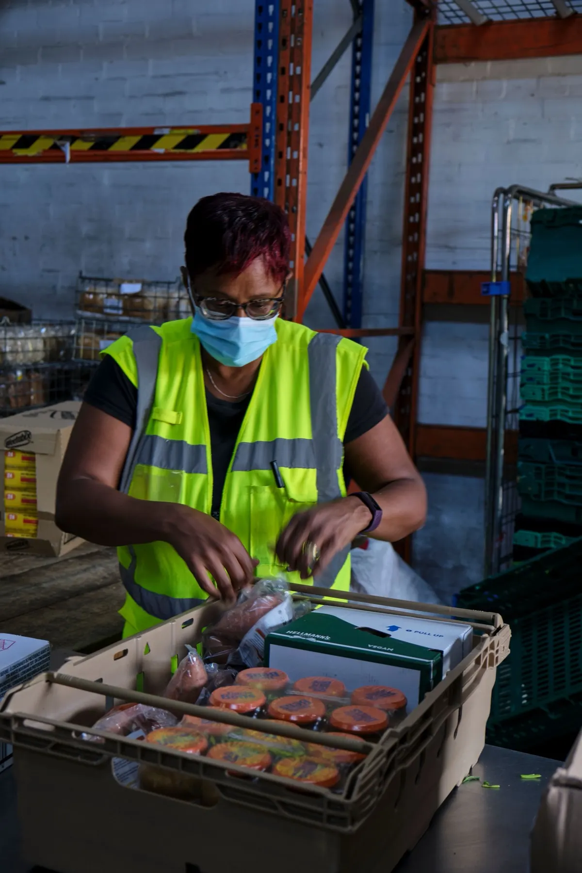A small-business operator packing food products at a worktable